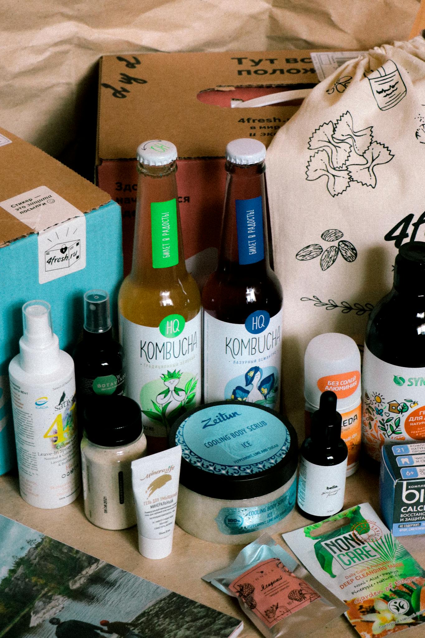 Collection of eco-friendly and natural cosmetic products including kombucha, creams, serums, and supplements.